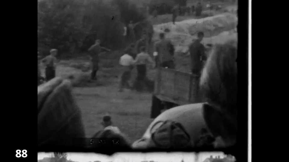 Screenshot from the Wiener Film mass execution in Liepaja 1942 fc 0088 - distant, a group is herded towards the pit